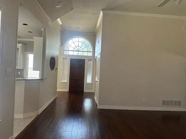 wooden floor in a hall with a window