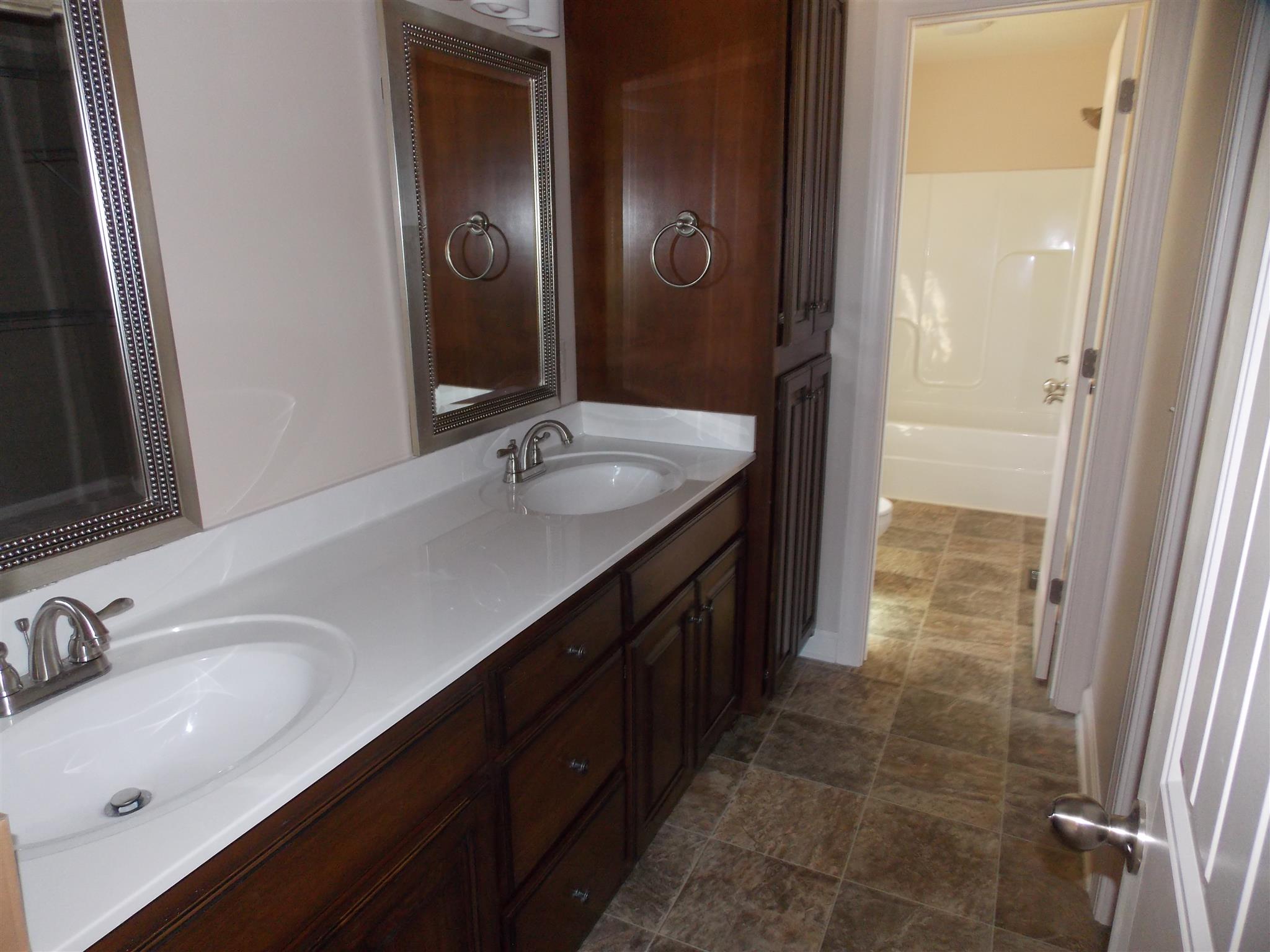 400 Goshen Road Lebanon, TN 37087 - Photo 7 of 20 a bathroom with a double vanity sink a mirror and a