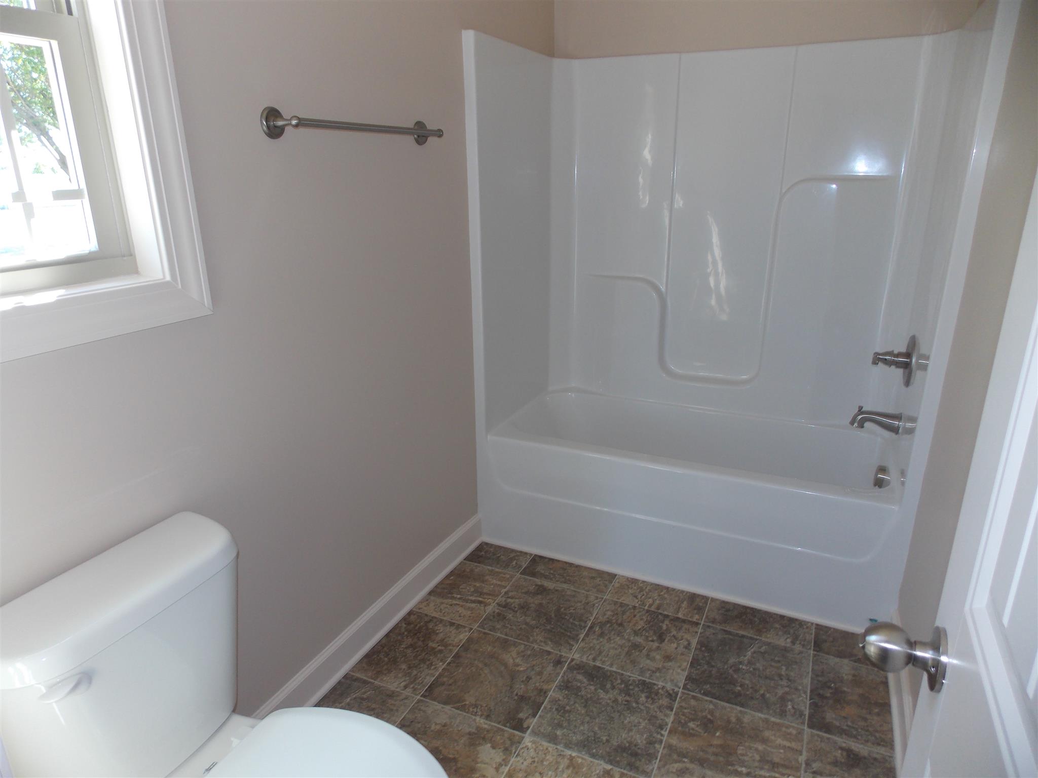 400 Goshen Road Lebanon, TN 37087 - Photo 9 of 20 a bathroom with a granite countertop toilet and a bathtub