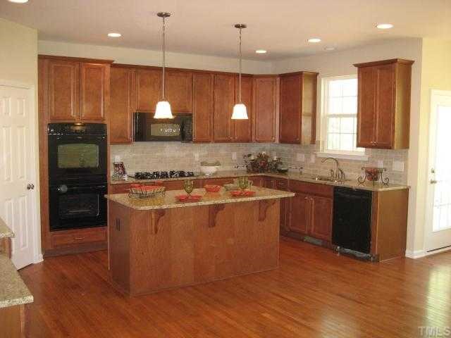 220 Forbes Road, Unit LOT13 Wake Forest, NC 27587 - Photo 3 of 12 Gourmet Kitchen / Maple cabinets / Granite Counters / Tile Backsplash / Double Ovens / 36" Gas Cooktop / Built-in Desk area too