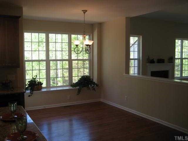 220 Forbes Road, Unit LOT13 Wake Forest, NC 27587 - Photo 4 of 12 Breakfast Area with 4' Nook Extension / Hardwood Floors / Single 15-Lite door to deck