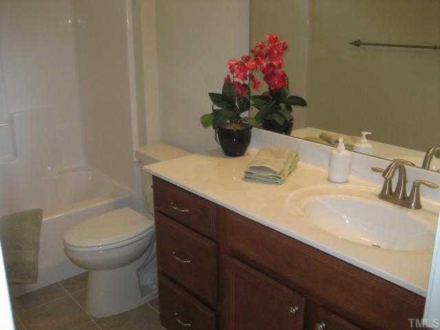 220 Forbes Road, Unit LOT13 Wake Forest, NC 27587 - Photo 7 of 12 1st Floor Guest Bath / Full Bath / Tile Floors / Brushed Nickel Hardware / Oversize maple vanity with drawers
