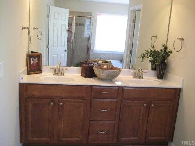 220 Forbes Road, Unit LOT13 Wake Forest, NC 27587 - Photo 9 of 12 Double Vanity in Tahoe Maple Cognac / Corner Soaking Tub with tile surround and two large glass block windows / seperate shower with tile surround / private water closet with window / tile floors