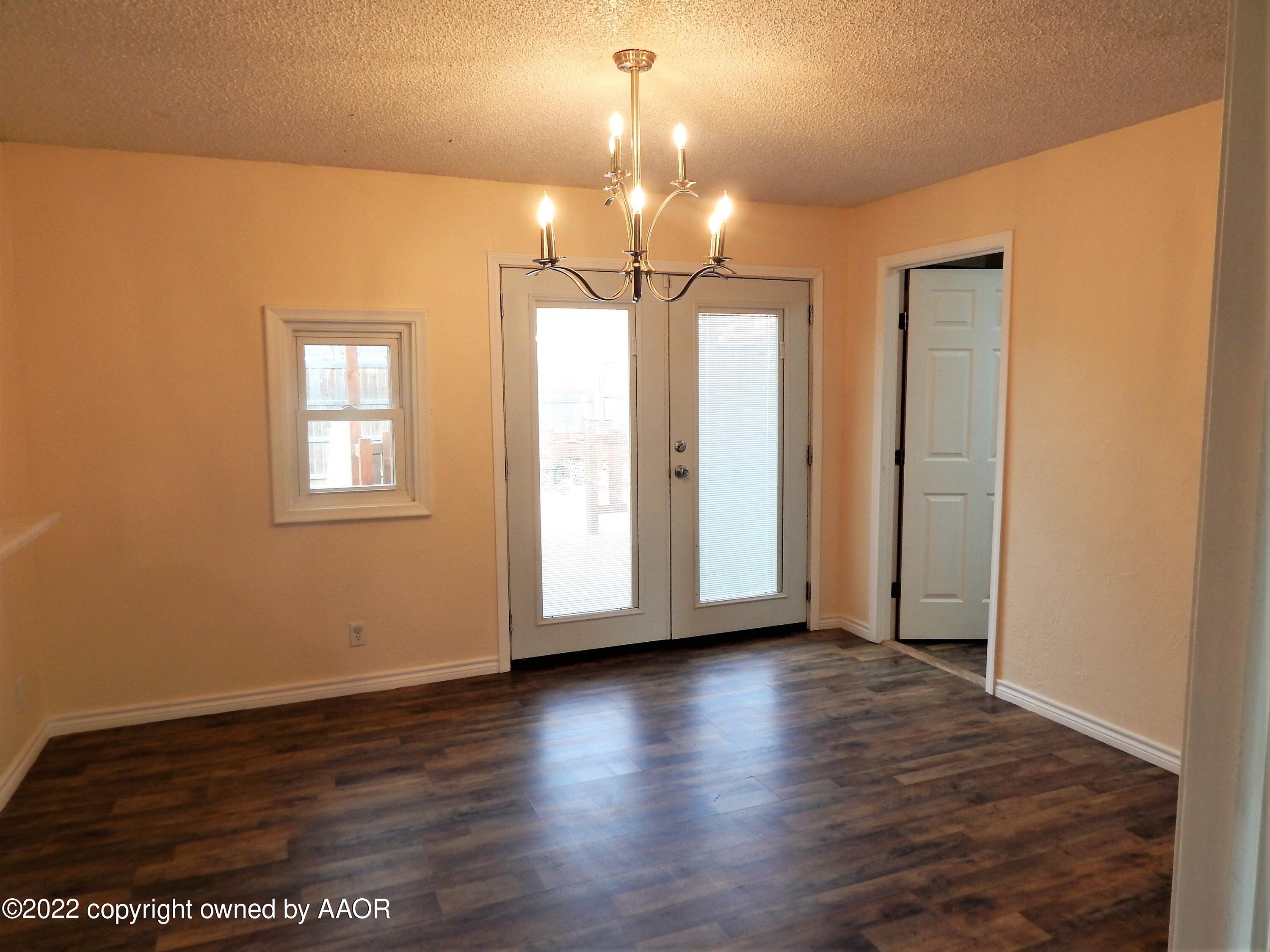 4202 South Lipscomb Street Amarillo, TX 79110 - Photo 8 of 25 a view of an empty room with wooden floor and a window