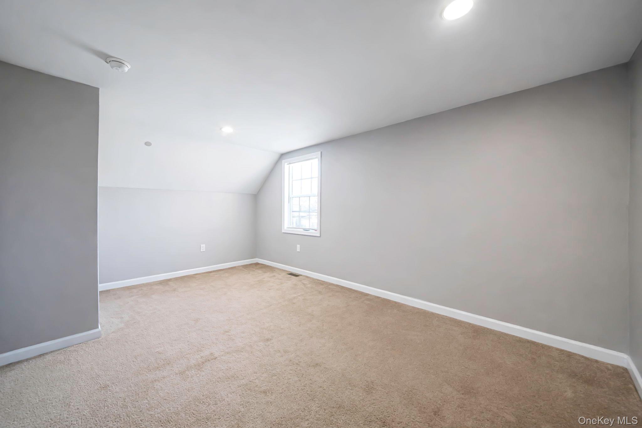 232 30th Street Lindenhurst, NY 11757 - Photo 13 of 46 an empty room with a window