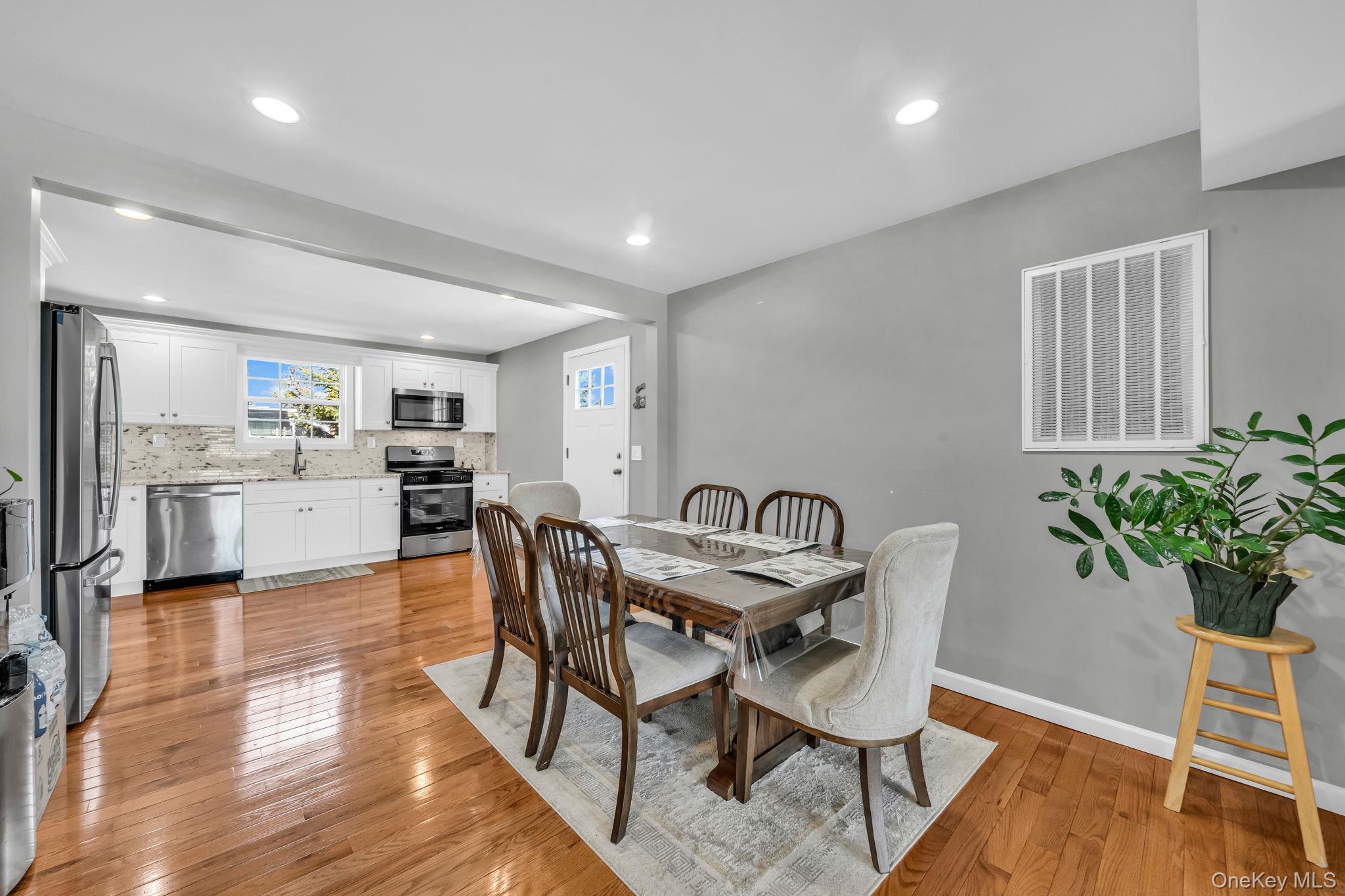 232 30th Street Lindenhurst, NY 11757 - Photo 20 of 46 a view of a dining room with furniture and wooden floor