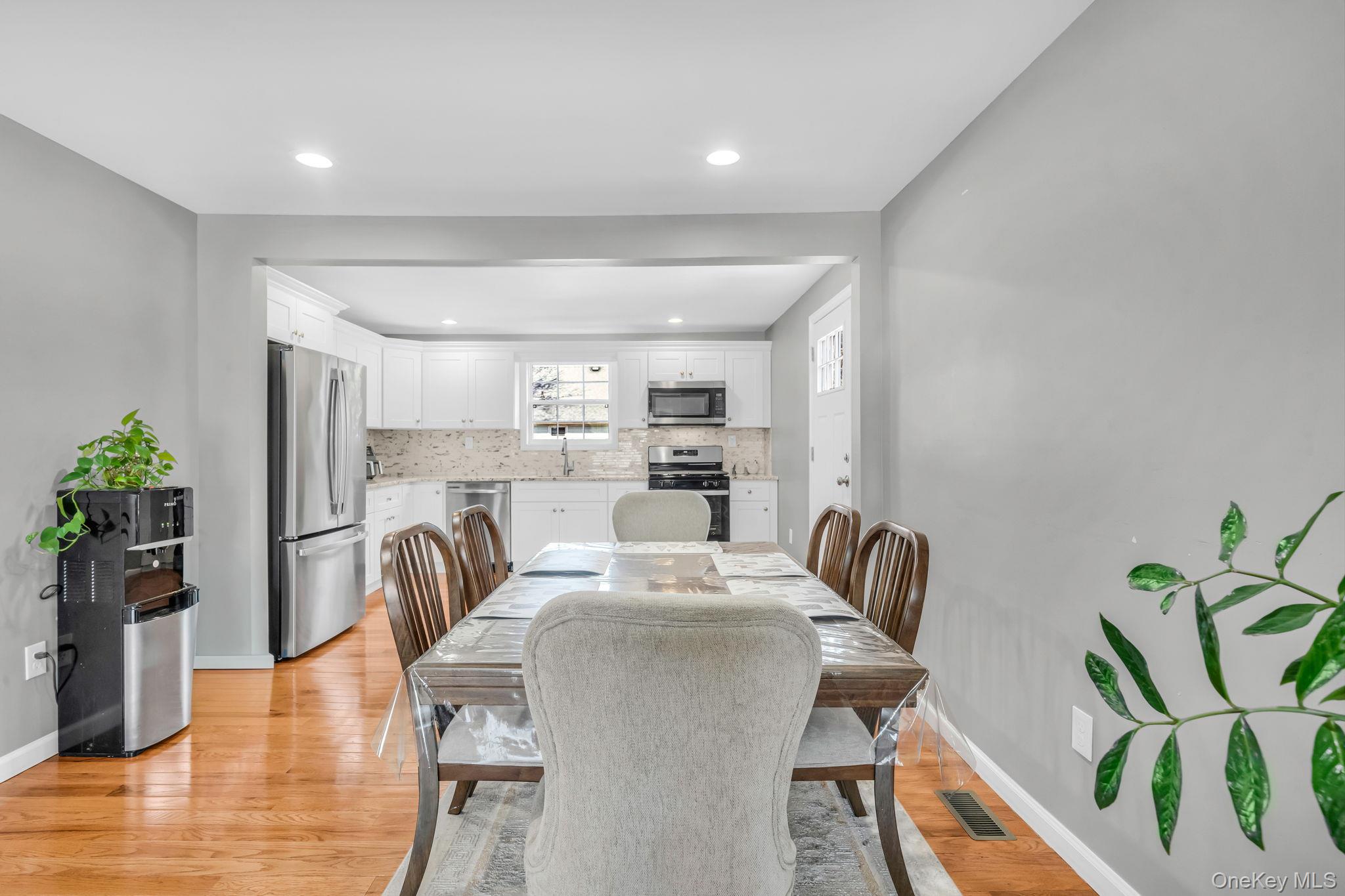 232 30th Street Lindenhurst, NY 11757 - Photo 21 of 46 a dining room with furniture and a floor to ceiling window