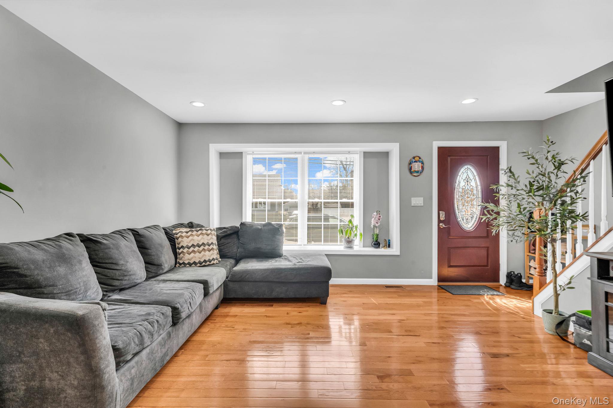 232 30th Street Lindenhurst, NY 11757 - Photo 23 of 46 a living room with furniture and a flat screen tv