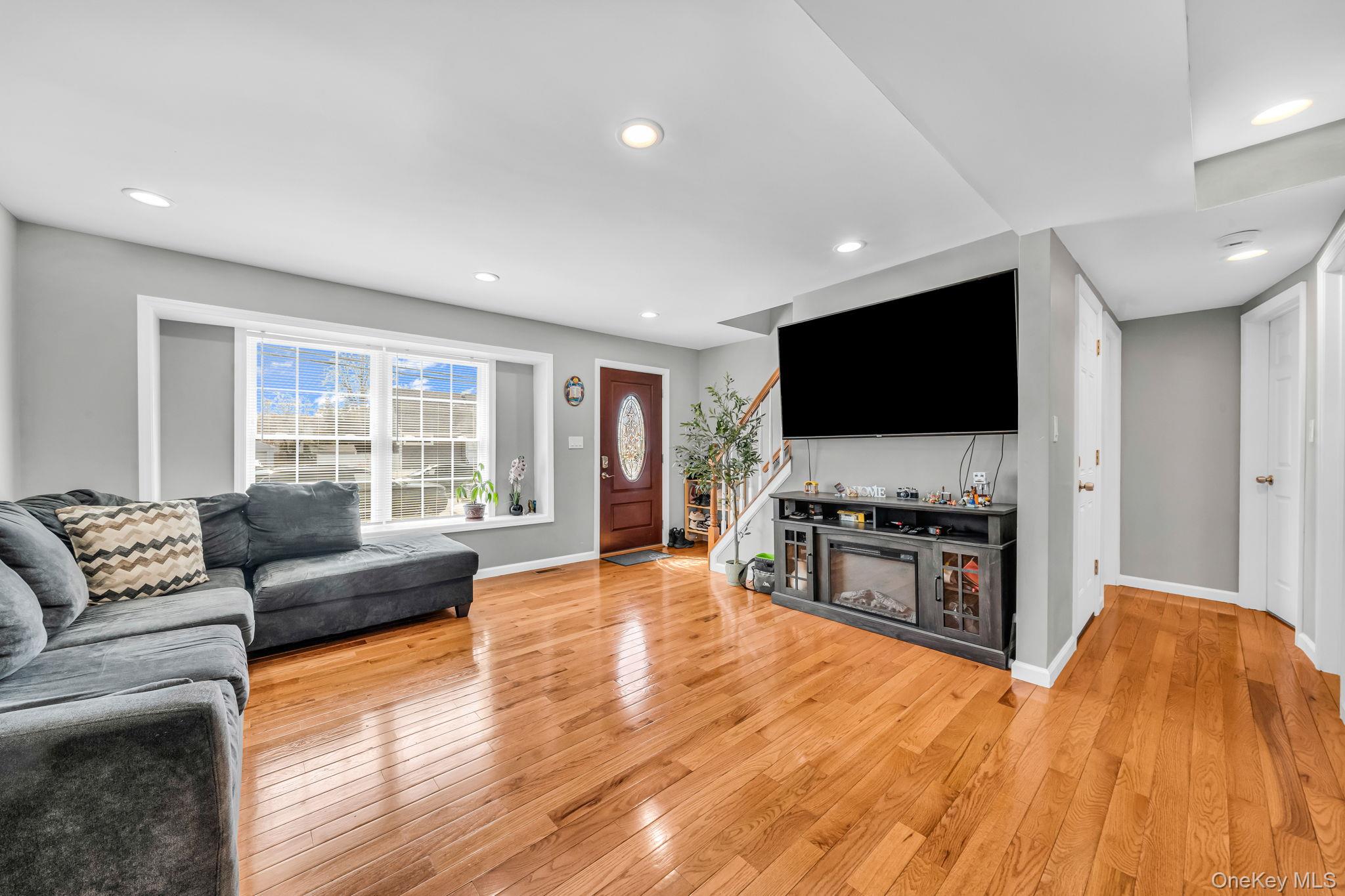 232 30th Street Lindenhurst, NY 11757 - Photo 24 of 46 a living room with furniture and a flat screen tv