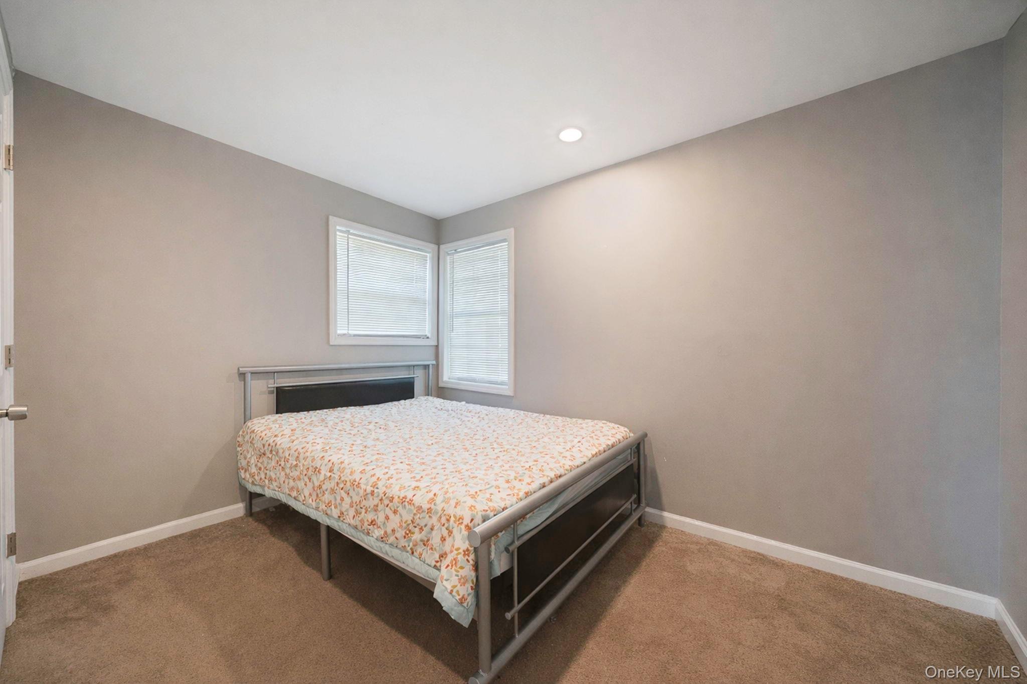 232 30th Street Lindenhurst, NY 11757 - Photo 27 of 46 a bedroom with a bed and window