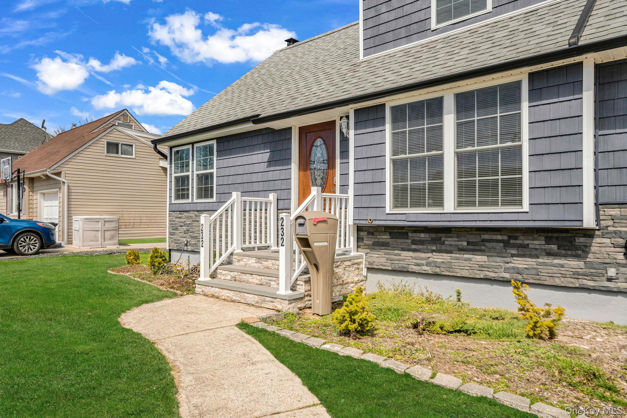 232 30th Street Lindenhurst, NY 11757 - Photo 3 of 46 a front view of a house with a yard