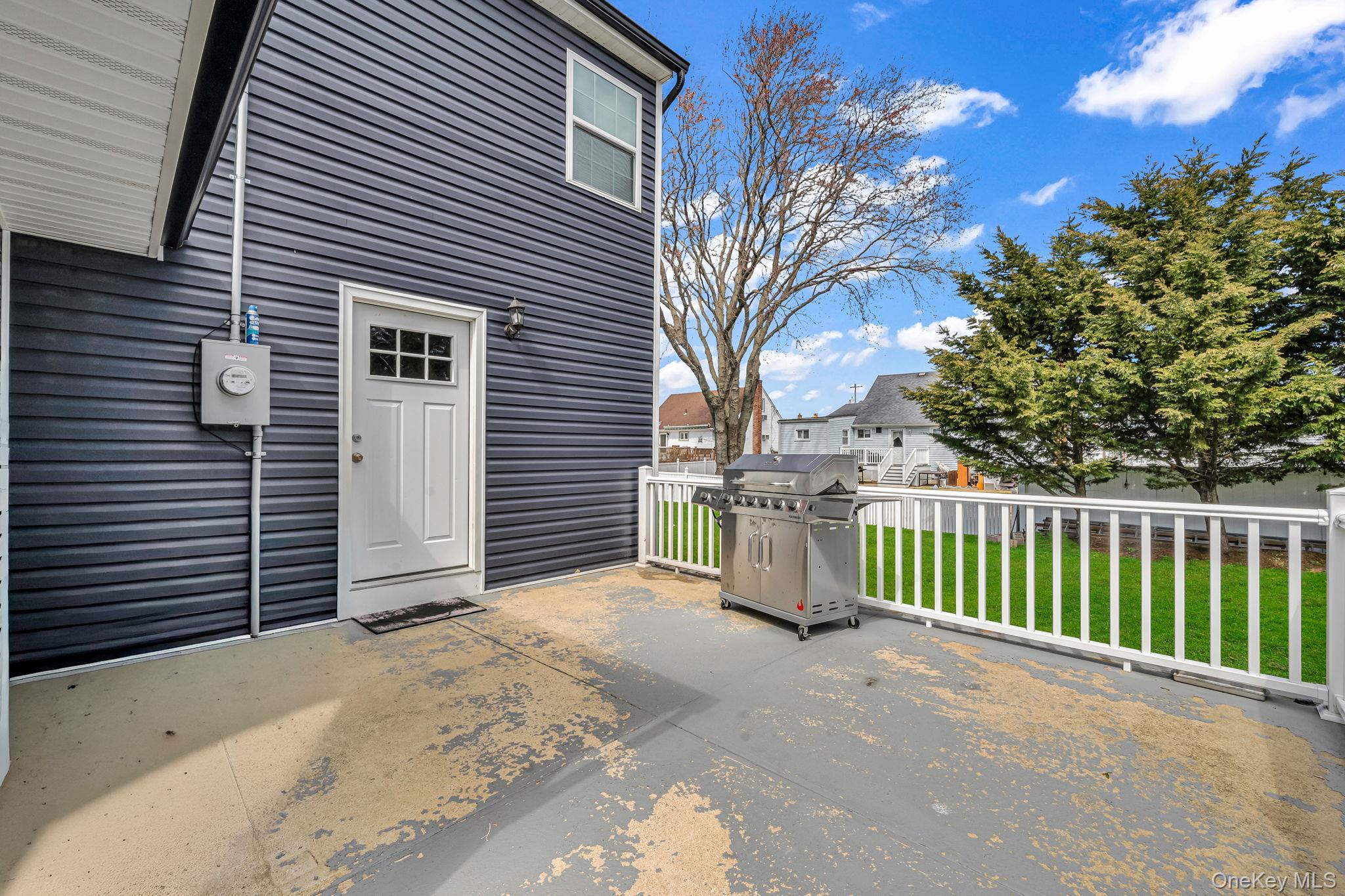 232 30th Street Lindenhurst, NY 11757 - Photo 34 of 46 a view of a house with a backyard and floor to ceiling window
