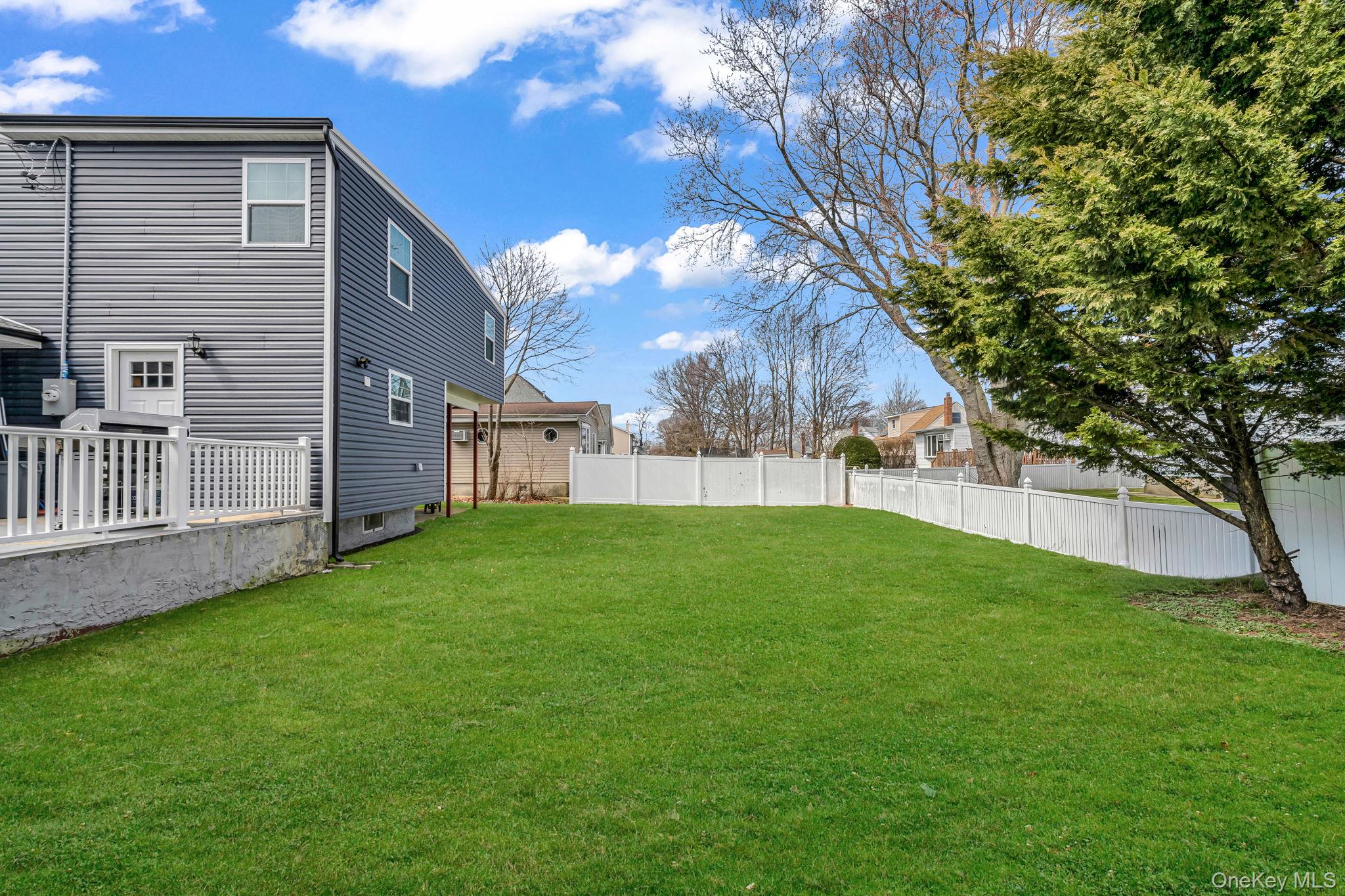 232 30th Street Lindenhurst, NY 11757 - Photo 39 of 46 a view of yard with grass and a large tree