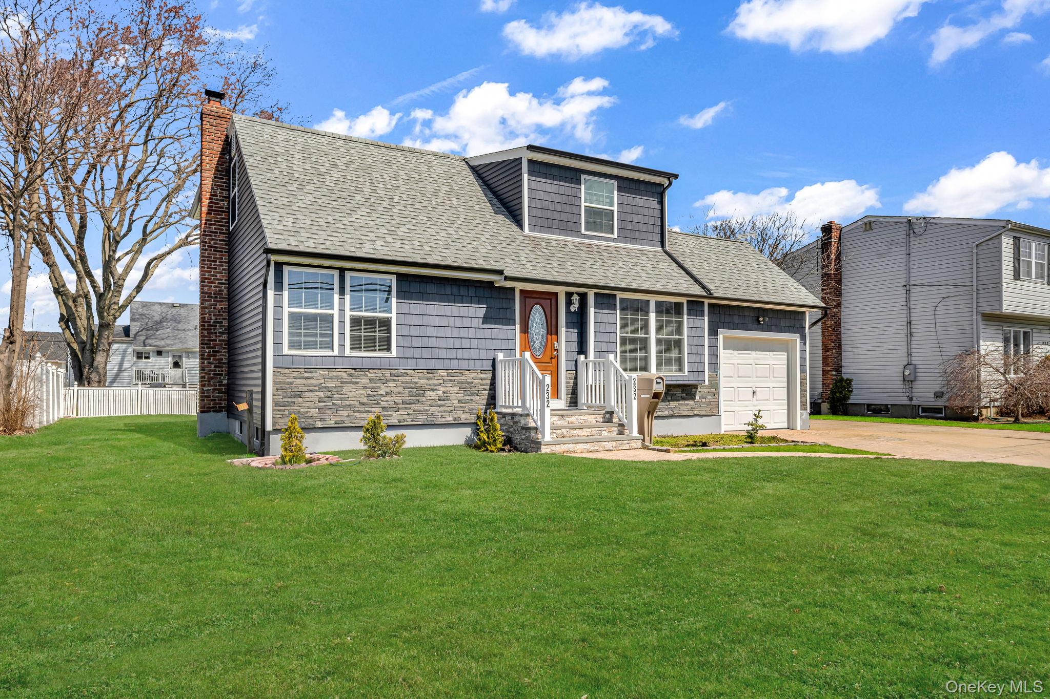 232 30th Street Lindenhurst, NY 11757 - Photo 4 of 46 a front view of a house with a yard