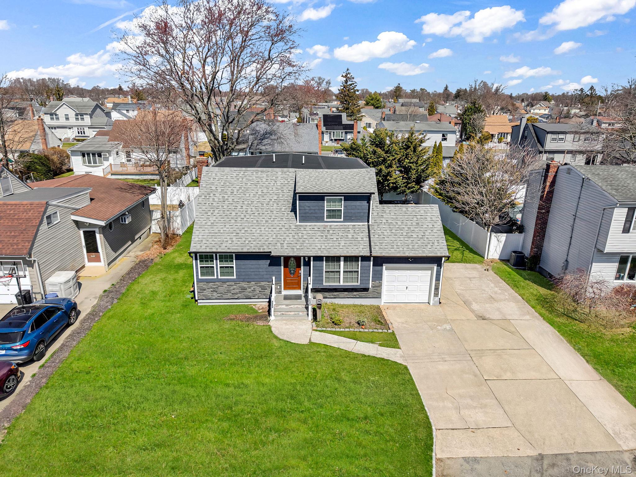 232 30th Street Lindenhurst, NY 11757 - Photo 5 of 46 an aerial view of a house with swimming pool and a yard