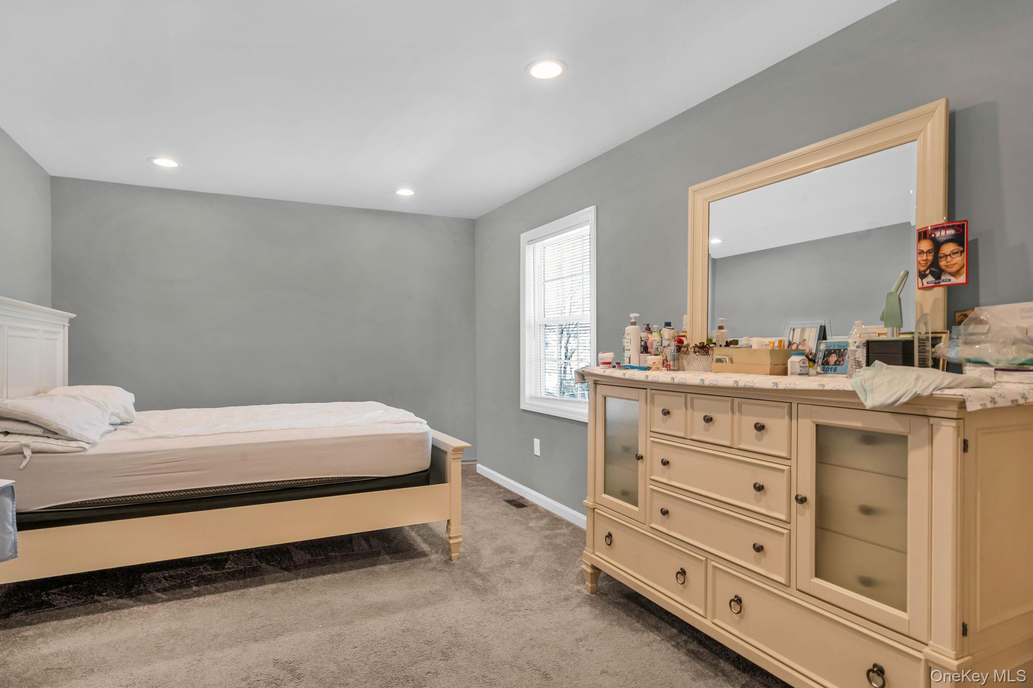232 30th Street Lindenhurst, NY 11757 - Photo 6 of 46 a bedroom with a bed and a dresser