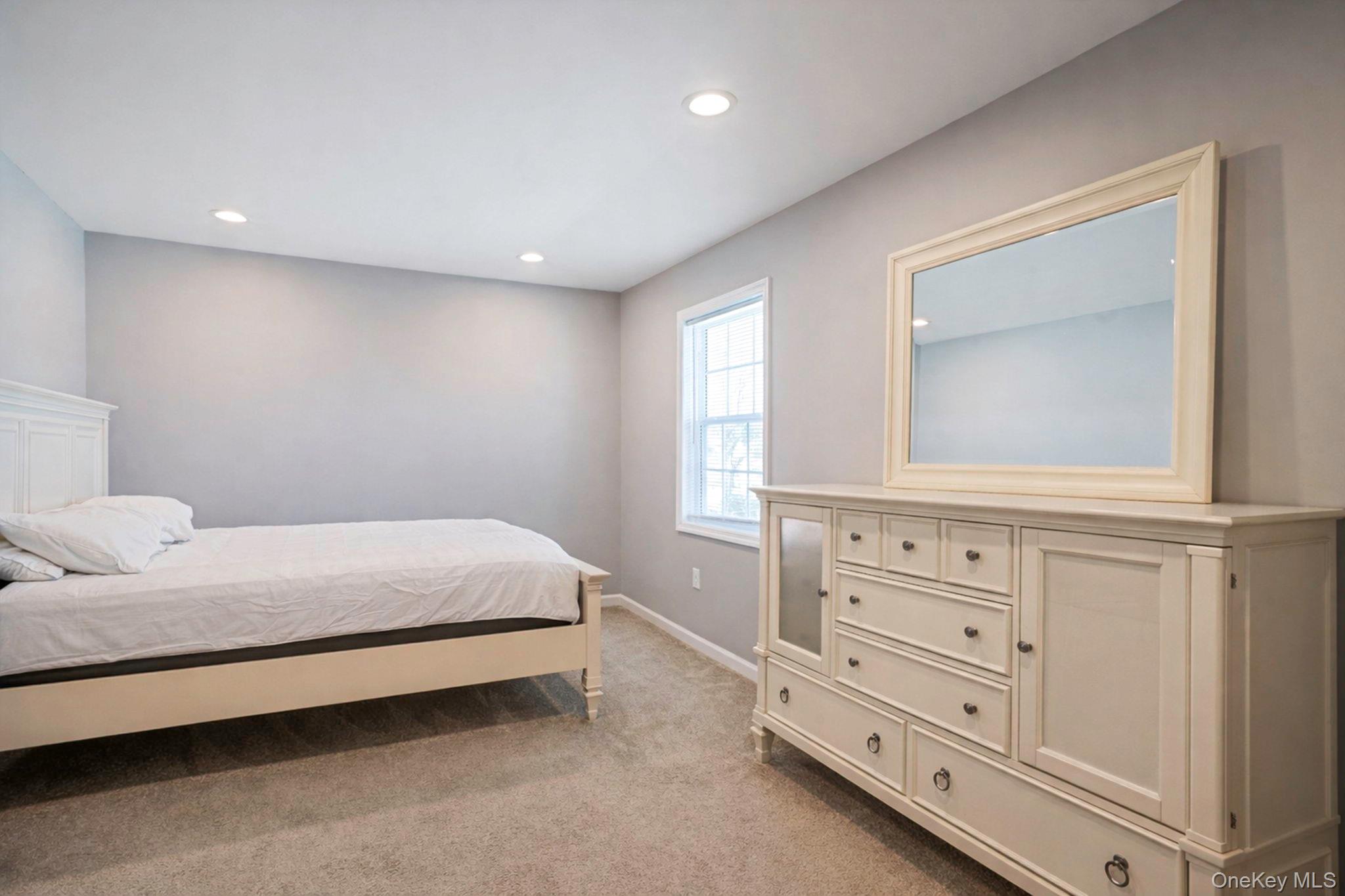 232 30th Street Lindenhurst, NY 11757 - Photo 7 of 46 a bedroom with a bed and a dresser