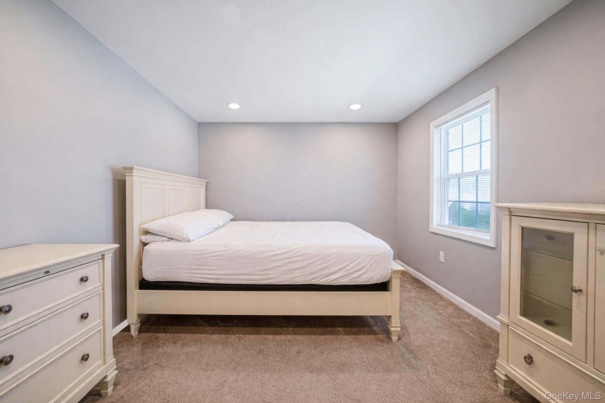 232 30th Street Lindenhurst, NY 11757 - Photo 8 of 46 a bedroom with a bed and a window