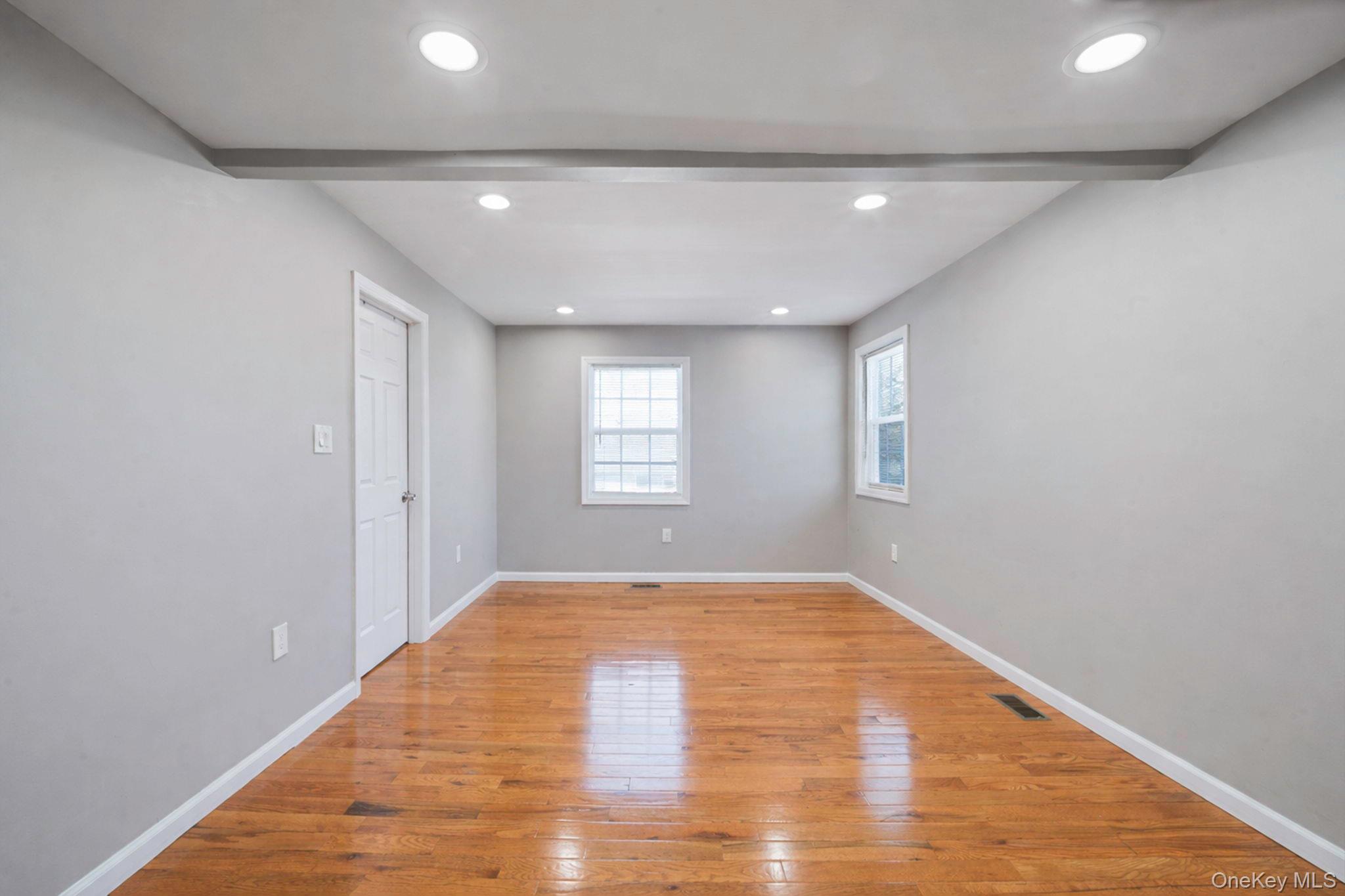 232 30th Street Lindenhurst, NY 11757 - Photo 10 of 46 a view of empty room with wooden floor and fan