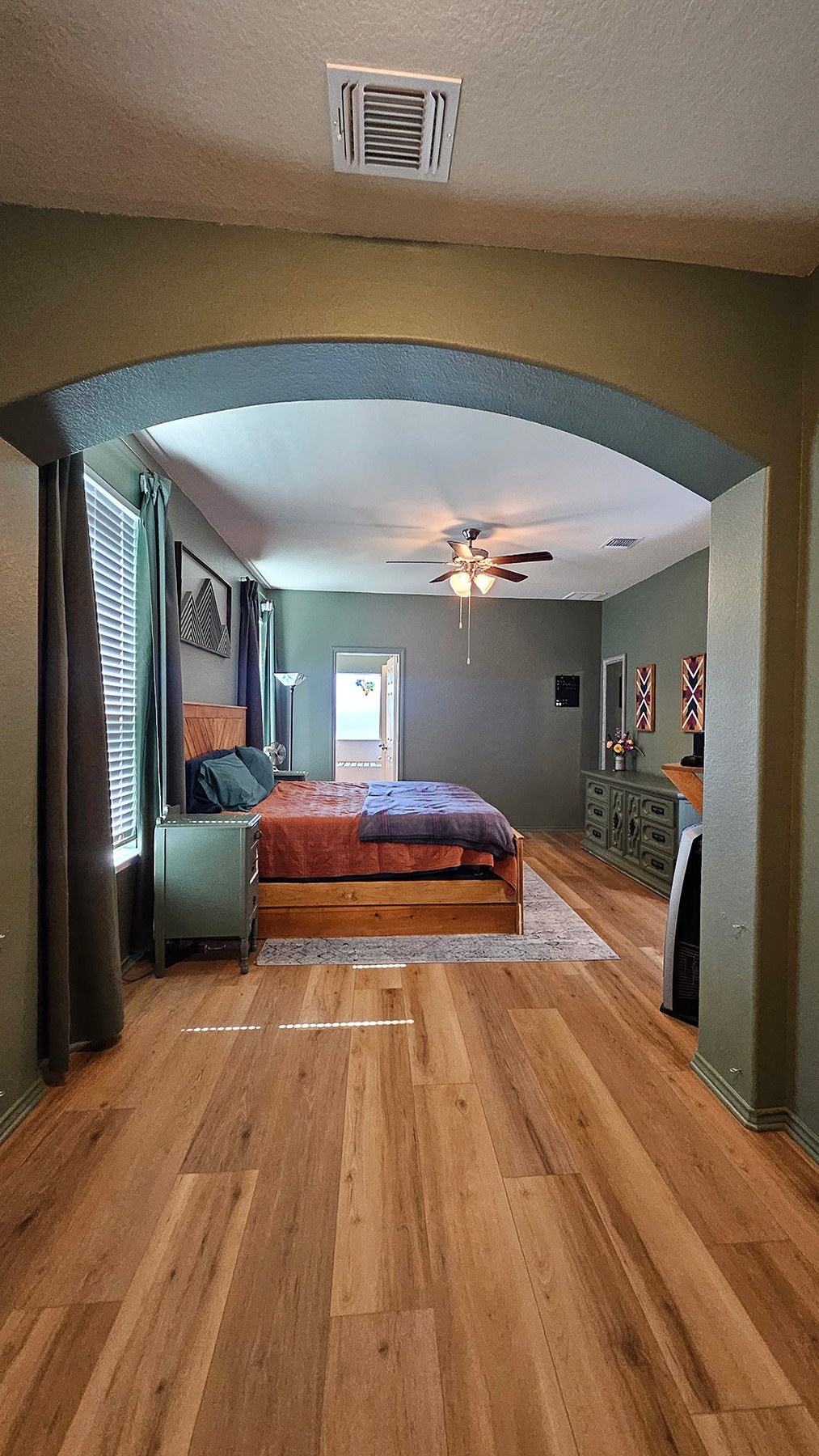 237 Bethann Drive Temple, TX 76502 - Photo 11 of 37 Archway entry into a room featuring wood-finish flooring, a ceiling fan, and window blinds
