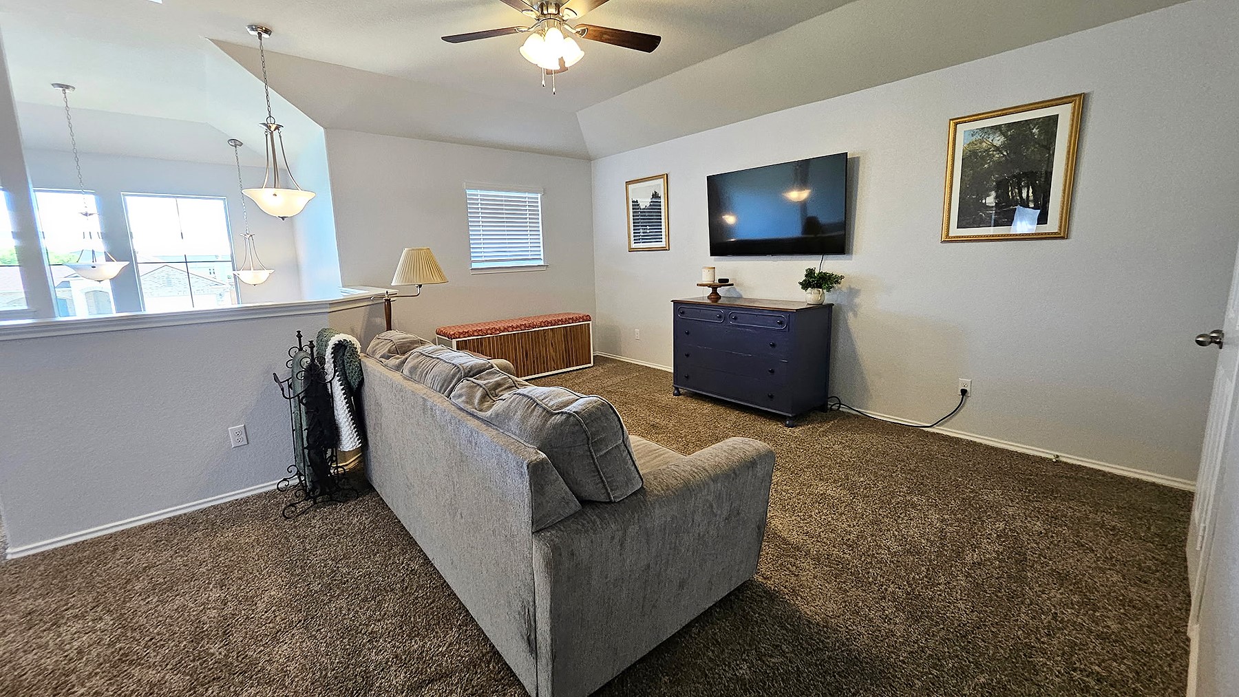 237 Bethann Drive Temple, TX 76502 - Photo 19 of 37 Carpeted living area featuring a ceiling fan with integrated lighting, a half-wall partition, and a window with blinds