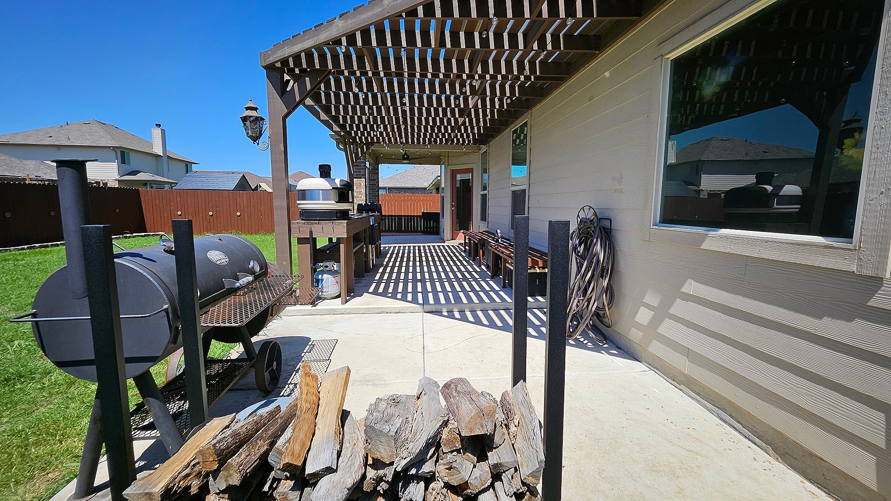 237 Bethann Drive Temple, TX 76502 - Photo 29 of 37 Expansive covered patio with a wood pergola structure, concrete flooring, and an outdoor built-in cabinetry and countertop area