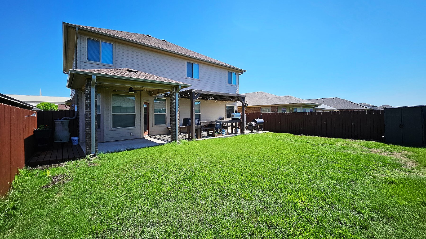 237 Bethann Drive Temple, TX 76502 - Photo 34 of 37 Expansive backyard featuring a green lawn, covered patio with brick pillars, and a wood pergola