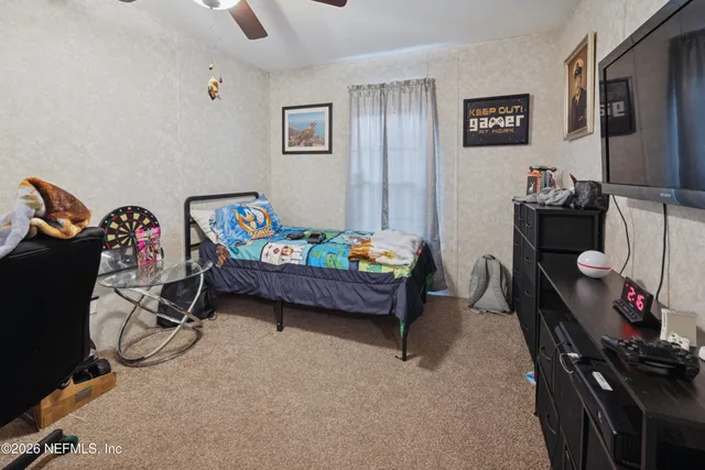 a bedroom with furniture and a gym equipment