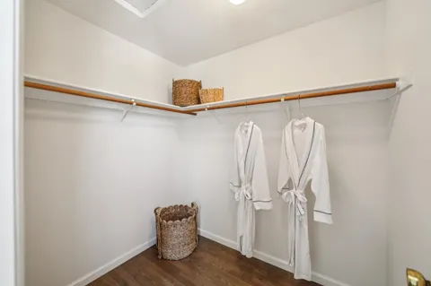 a view of closet with wooden floor