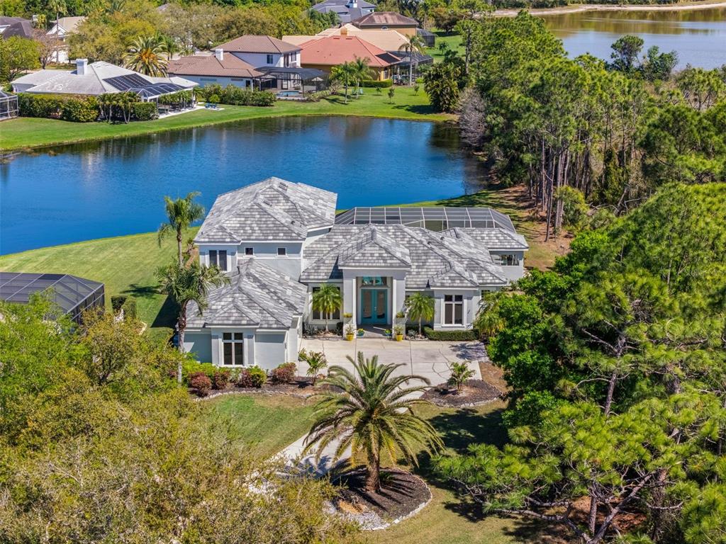 an aerial view of a house with a lake view
