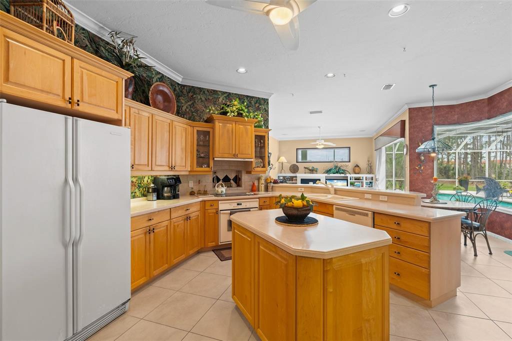 7517 Coventry Court Lakewood Ranch, FL 34202 - Photo 21 of 96 a kitchen with a sink a counter top space a stove and cabinets