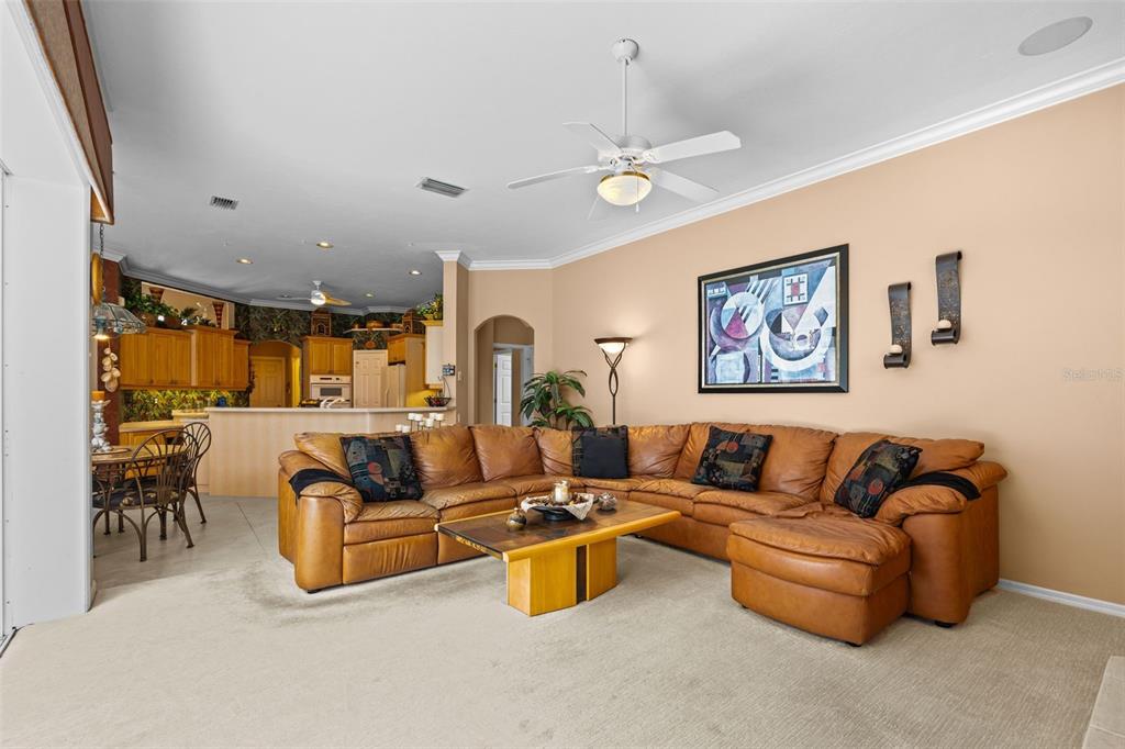 7517 Coventry Court Lakewood Ranch, FL 34202 - Photo 30 of 96 a living room with furniture and a chandelier