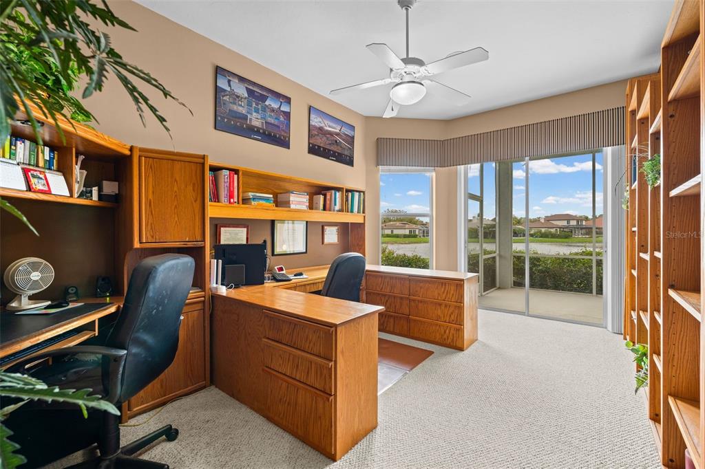 7517 Coventry Court Lakewood Ranch, FL 34202 - Photo 32 of 96 a living room with furniture and a floor to ceiling window