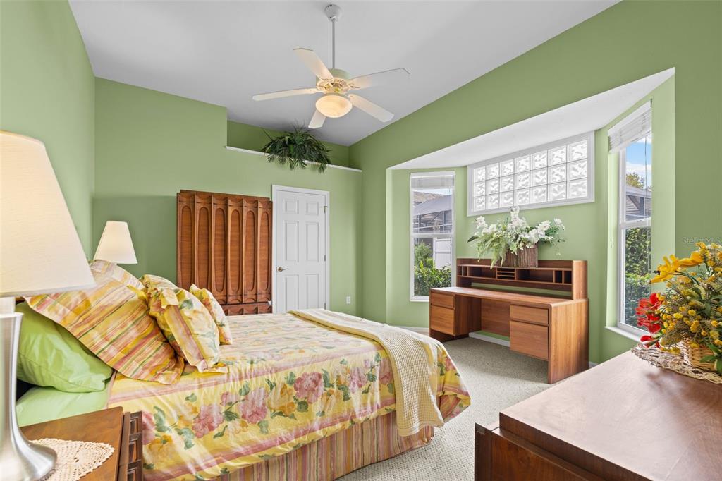 7517 Coventry Court Lakewood Ranch, FL 34202 - Photo 37 of 96 a spacious bedroom with a bed and a chandelier