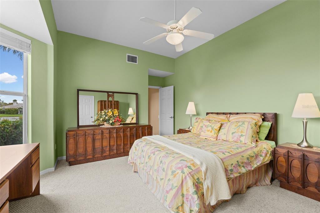 7517 Coventry Court Lakewood Ranch, FL 34202 - Photo 38 of 96 a bedroom with a bed and a chandelier