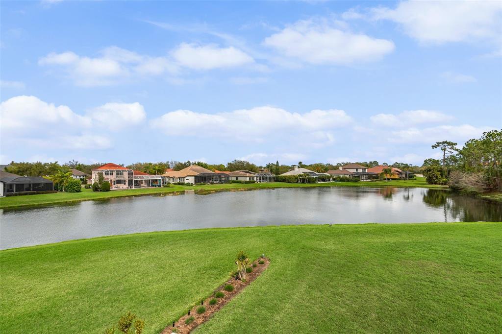 7517 Coventry Court Lakewood Ranch, FL 34202 - Photo 43 of 96 a view of a lake with houses in the back