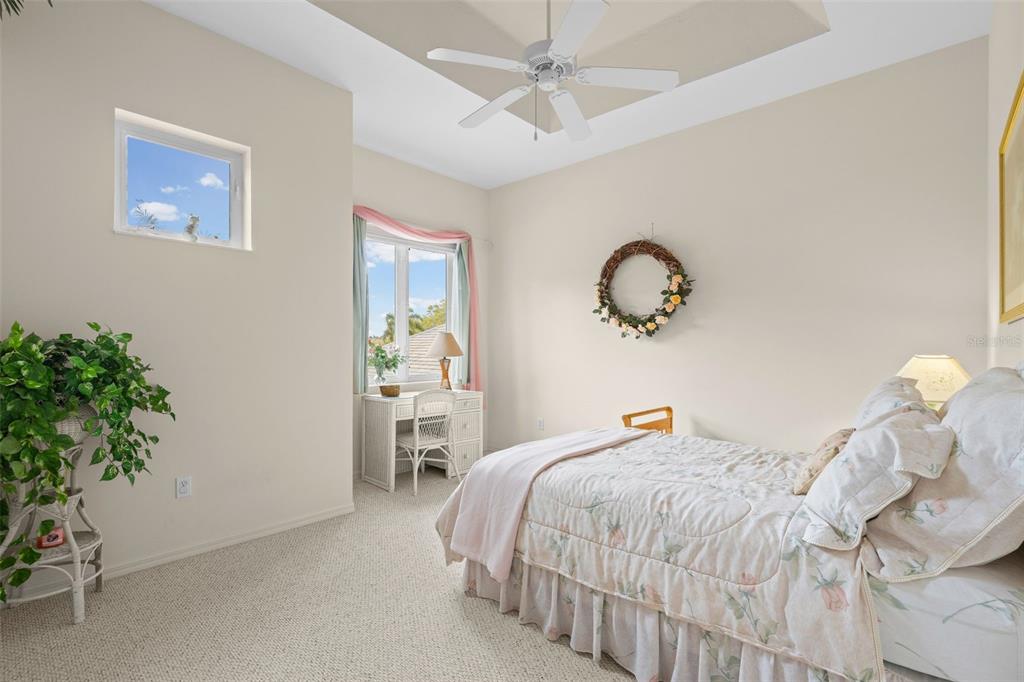 7517 Coventry Court Lakewood Ranch, FL 34202 - Photo 50 of 96 a bedroom with a bed and a chandelier