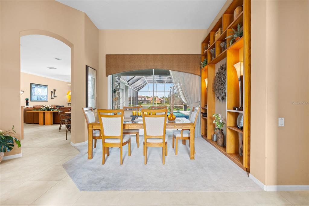 7517 Coventry Court Lakewood Ranch, FL 34202 - Photo 8 of 96 a dining room with stainless steel appliances granite countertop a couch and a view of living room