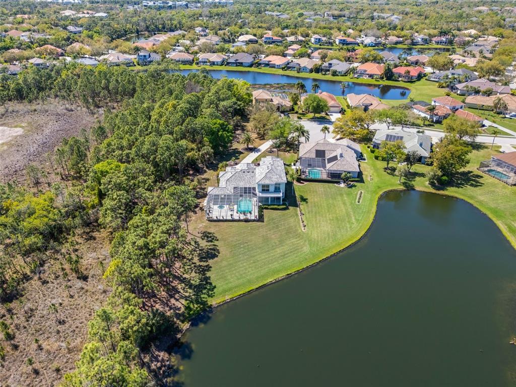 7517 Coventry Court Lakewood Ranch, FL 34202 - Photo 81 of 96 an aerial view of residential houses with outdoor space and lake view
