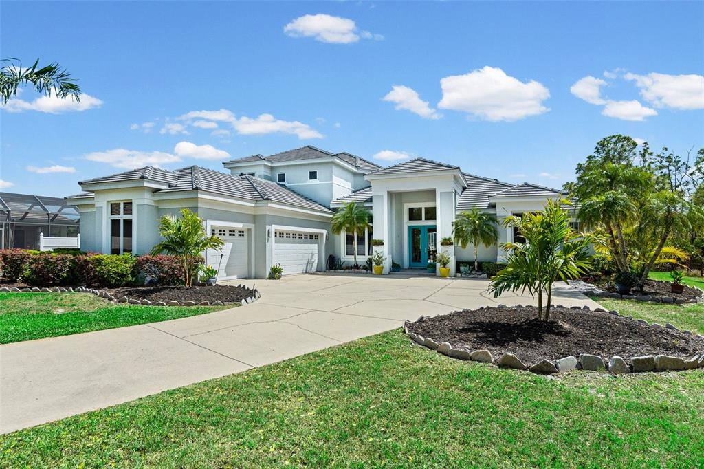 7517 Coventry Court Lakewood Ranch, FL 34202 - Photo 93 of 96 a view of a house with a yard and potted plants