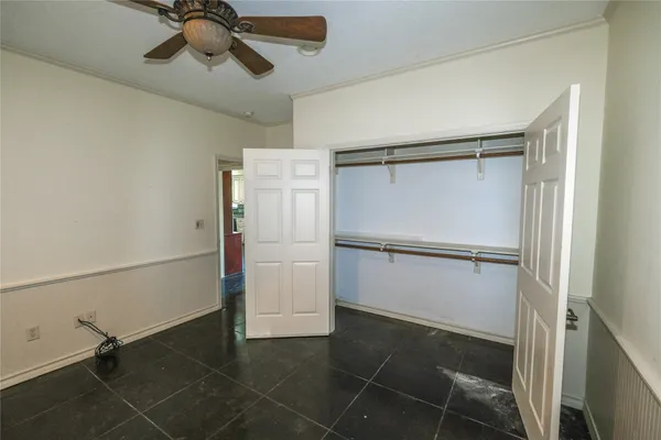 a view of walk in closet with empty racks