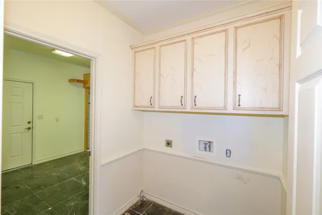 a front view of a house with a tree