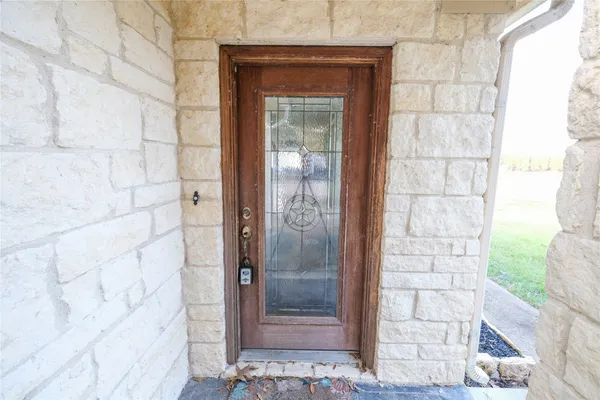 a view of a wooden door of the house