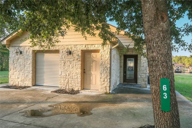a view of a porch with furniture and garden