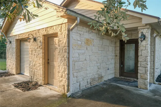 a view of a house with yard and sitting area