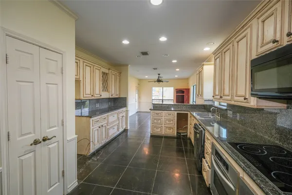 a kitchen with stainless steel appliances a stove a sink and a microwave