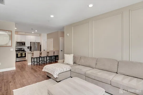 a living room with furniture and kitchen view