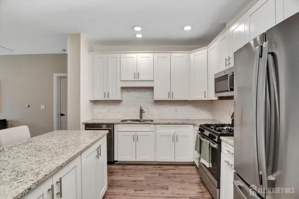 a kitchen with a sink stove and refrigerator