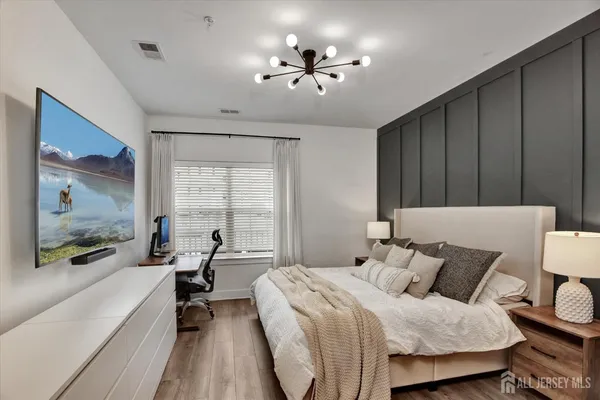 a bed room with a bed window and a television