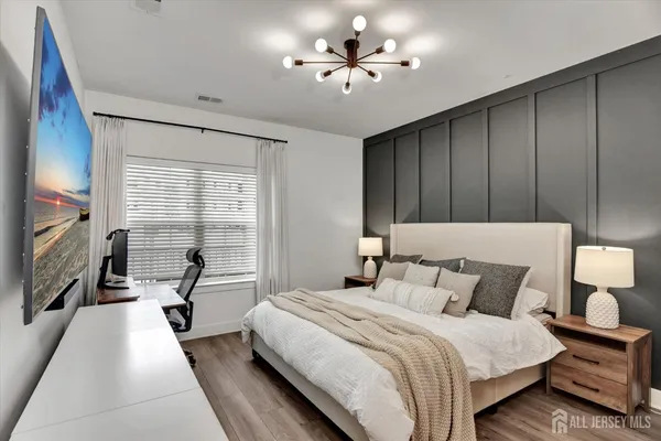 a bedroom with a bed and a chandelier
